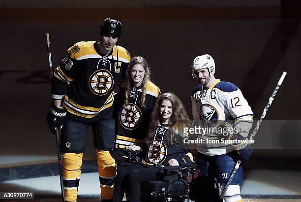 Denna Laing and her sister Lexie pose with Boston Bruins left defenseman Zdeno Chara and Buffalo Sabres right wing Brian Gionta after the ceremonial...