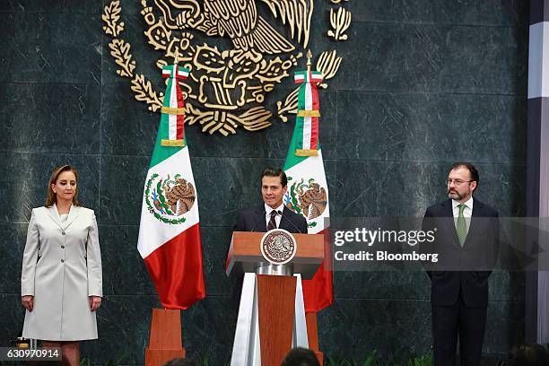 Enrique Pena Nieto, Mexico's president, center, speaks while Claudia Ruiz Massieu Salinas, Mexico's former minister of foreign affairs, left, and...