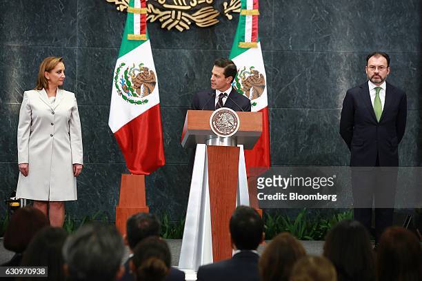 Enrique Pena Nieto, Mexico's president, center, speaks while Claudia Ruiz Massieu Salinas, Mexico's former minister of foreign affairs, left, and...