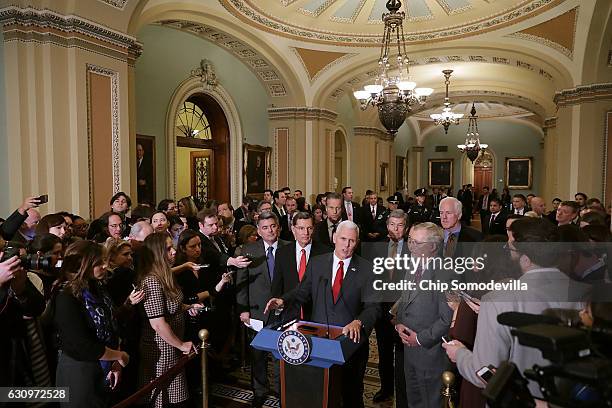 Vice President-elect Mike Pence talks with reporters after attending a caucus meeting with Senate Majority Leader Mitch McConnell and other GOP...