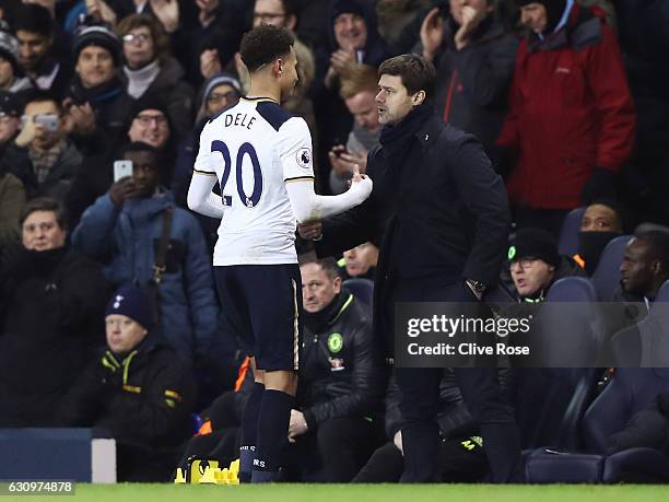 Dele Alli of Tottenham Hotspur and Mauricio Pochettino, Manager of Tottenham Hotspur embrace after he is subbed during the Premier League match...