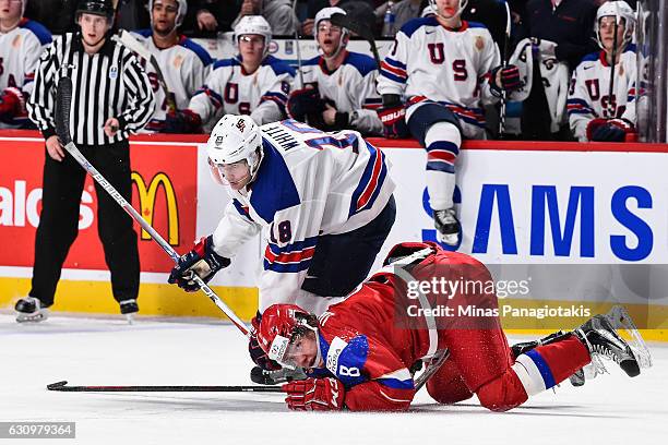 Colin White of Team United States takes down Kirill Urakov of Team Russia during the 2017 IIHF World Junior Championship semifinal game at the Bell...