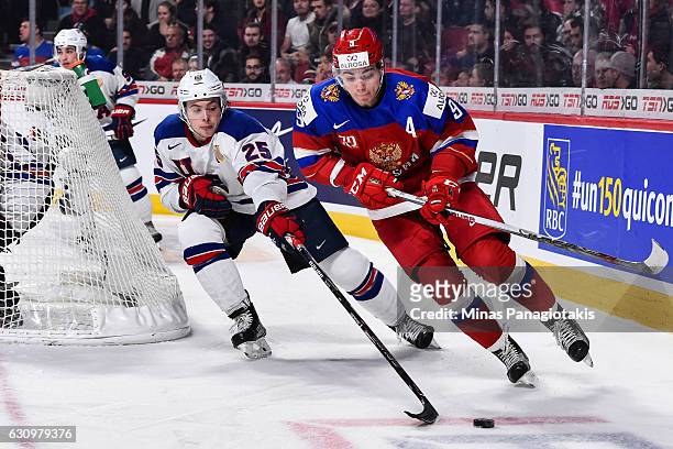 Danila Kvartalnov of Team Russia skates the puck against Charlie McAvoy of Team United States during the 2017 IIHF World Junior Championship...