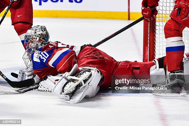 Ilya Samsonov of Team Russia covers the puck during the 2017 IIHF World Junior Championship semifinal game against Team United States at the Bell...