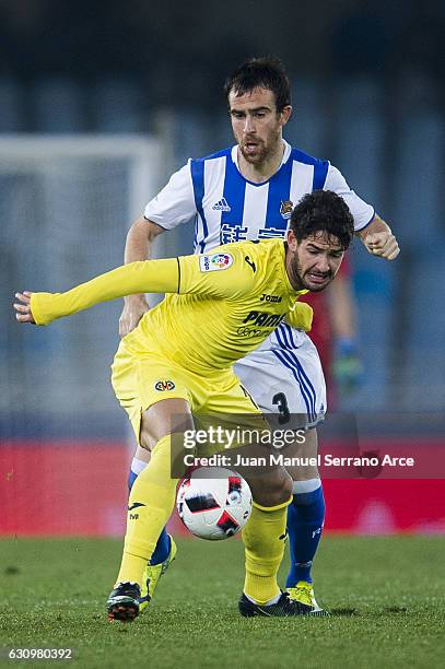 Mikel Gonzalez of Real Sociedad duels for the ball with Alexandre Rodrigues 'Pato' of Villarreal CF during the Copa del Rey Round of 16 first leg...