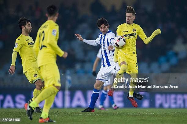 Esteban Granero of Real Sociedad duels for the ball with Samuel Castillejo of Villarreal CF during the Copa del Rey Round of 16 first leg match...