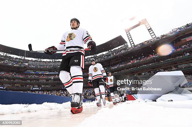 Jordin Tootoo of the Chicago Blackhawks makes his way to the ice surface with his teammates for the 2017 Bridgestone NHL Winter Classic at Busch...