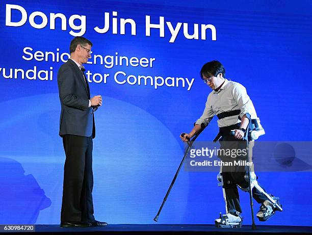 Hyundai Motor Co. Vice President Mike O'Brien looks on as Hyundai Motor Co. Senior engineer Dr. Dong Jin Hyun demonstrates the H-Mex Hyundai Medical...