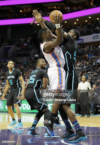 Victor Oladipo of the Oklahoma City Thunder tries to shoot over Roy Hibbert of the Charlotte Hornets during their game at Spectrum Center on January...