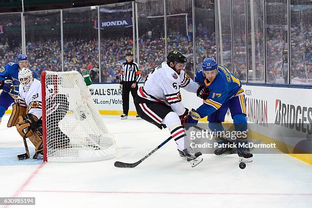 Michal Kempny of the Chicago Blackhawks and Jaden Schwartz of the St. Louis Blues vie for the puck behind the net during the 2017 Bridgestone NHL...