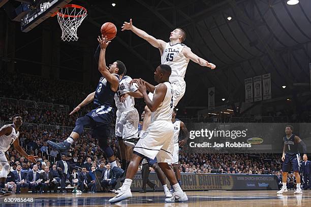 Andrew Chrabascz of the Butler Bulldogs defends against Josh Hart of the Villanova Wildcats in the first half of the game at Hinkle Fieldhouse on...