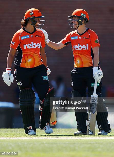 Elyse Villani of the Scorchers congratulates Suzie Bates of the Scorchers on reaching 50 runs during the Women's Big Bash League match between the...