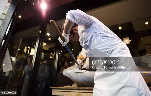 Kiyomura Co. Employee cuts a fresh bluefin tuna in front of one of the company's Sushi Zanmai sushi restaurants after the year's first auction at...