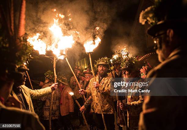 Members of the Leominster Morris lead the crowd from the Hobson Brewery in Frith Common to the nearby apple orchard to take part in a torchlit...