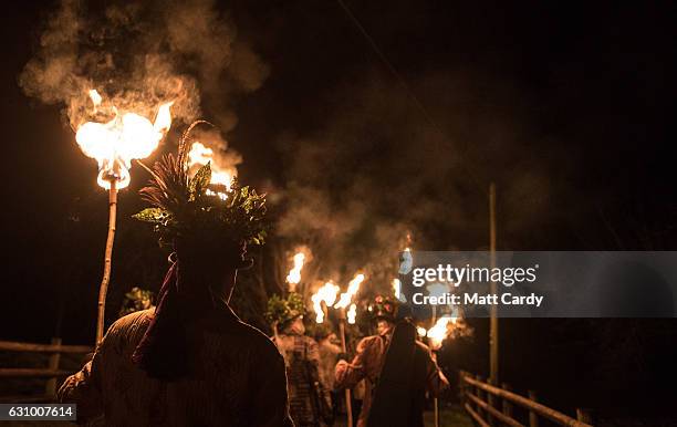 Members of the Leominster Morris lead the crowd from the Hobson Brewery in Frith Common to the nearby apple orchard to take part in a torchlit...