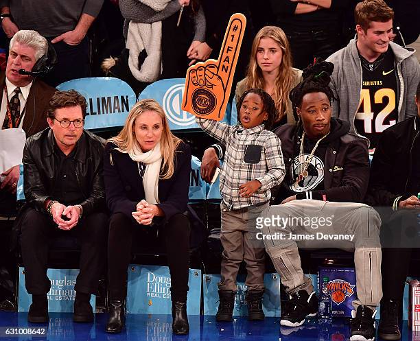 Michael J. Fox, Tracy Pollan and Janoris Jenkins and his son attend Milwaukee Bucks vs. New York Knicks game at Madison Square Garden on January 4,...