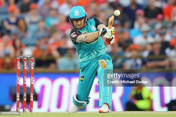 Brendon McCullum of the Heat breaks his bat from this stroke during the Big Bash League match between the Perth Scorchers and the Brisbane Heat at...