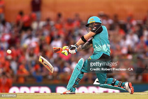 Brendon McCullum of the Heat breaks his bat as he plays a shot during the Big Bash League match between the Perth Scorchers and the Brisbane Heat at...