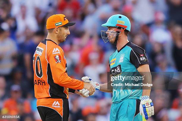 Chris Lynn of the Heat shakes the hand of Shaun Marsh of the Scorchers after hitting the winning runs during the Big Bash League match between the...