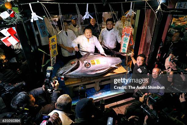 Kiyomura Co. President Kiyoshi Kimura poses with a fresh bluefin tuna before cutting it in front of one of the company's Sushi Zanmai sushi...