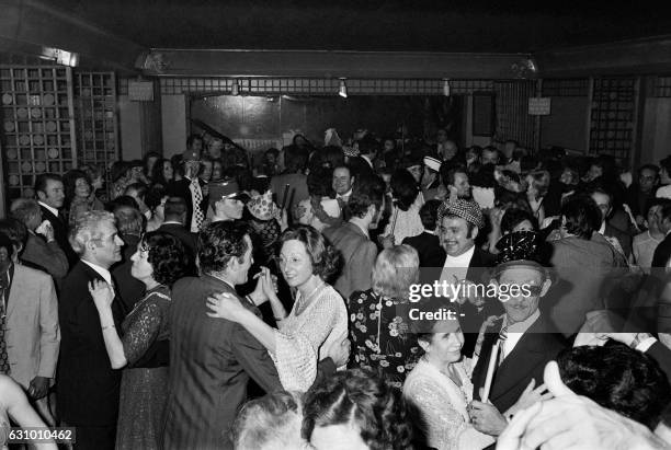 People dance to celebrate the new year eve on December 31, 1974 in a nightclub in Paris.