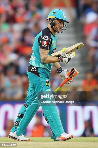 Brendon McCullum of the Heat reacts after breaking his bat from playing a stoke off the bowling of Andrew Tye of the Scorchers during the Big Bash...