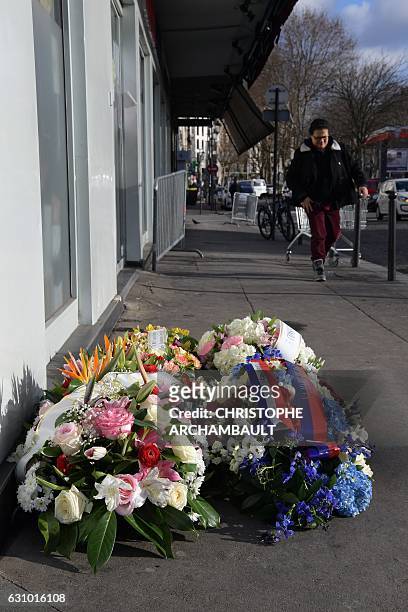 Man walks past flowers laid at the site of the deadly attack against the Hyper Cacher supermarket following a ceremony marking its second anniversary...