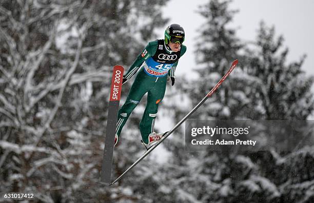 Jurij Tepes of Slovenia of Germany soars through the air during his training jump on Day 1 of the 65th Four Hills Tournament ski jumping event on...