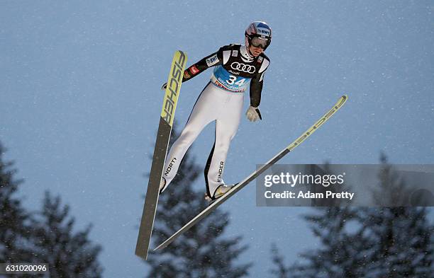 Lukas Hlava of Czech Republic soars through the air during his training jump on Day 1 of the 65th Four Hills Tournament ski jumping event on January...