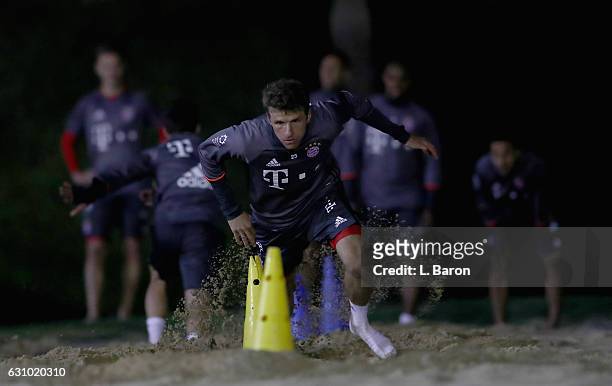 Thomas Mueller sprints in the sand during a training session at day 3 of the Bayern Muenchen training camp at Aspire Academy on January 5, 2017 in...