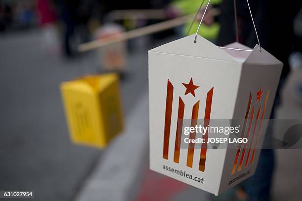 People hold paper lanterns cut-out of an Estelada, a Catalan Pro-independence flag during the Three Wise Men Parade in Vic on January 5 marking the...