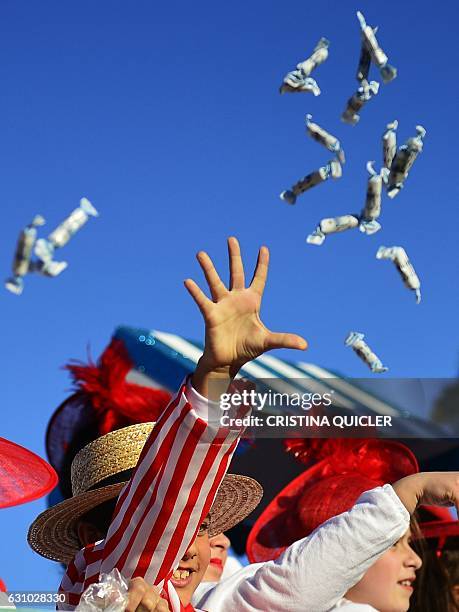 Young participants throw candies during the Three Wise Men Parade in Sevilla on January 5 marking the eve of Epiphany. Each year, parades are held...