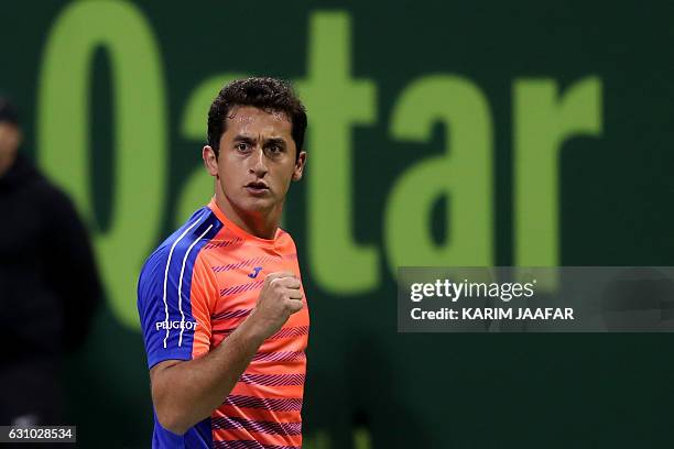 Spain's Nicolas Almagro reacts as he plays against Britain's Andy Murray during the quarter-final of the ATP Qatar Open tennis competition in Doha on...