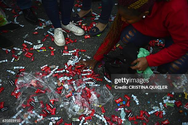 Girl collects candies on the ground during the Three Wise Men Parade in Sevilla on January 5 marking the eve of Epiphany. Each year, parades are held...