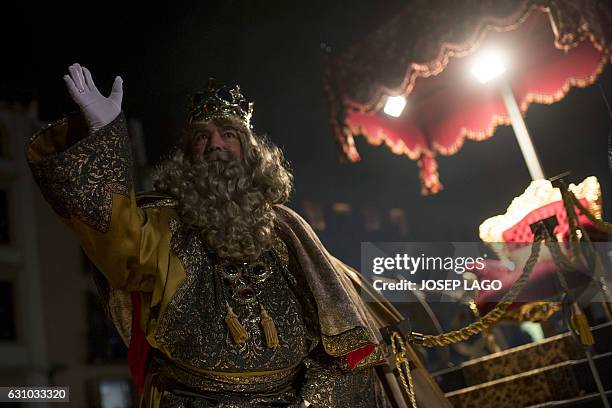 Man dressed as King Melchior, one of the three wise men or the Three Kings waves during the Three Wise Men Parade in Vic on January 5 marking the eve...