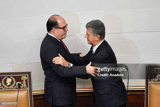 Opposition's parliamentary leader Julio Borges greets outgoing President Henry Ramos Allup during the swearing-in ceremony for outgoing assembly...