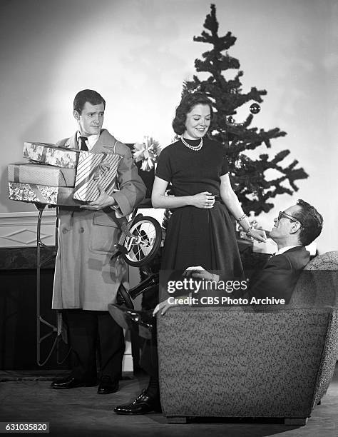 Televisions Studio One featuring Orson Bean , Kathleen McGuire , and Robert Q. Lewis in A Christmas Surprise. The production resembles an interview...