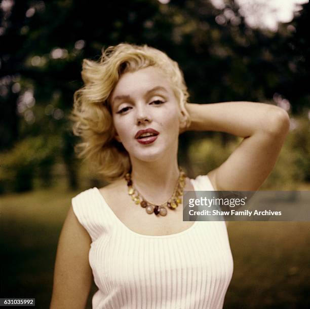 Marilyn Monroe poses wearing an amber bead necklace in 1957 in Amagansett, New York.