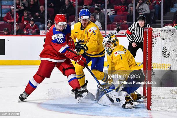 Goaltender Felix Sandstrom of Team Sweden makes a pad save on Alexander Polunin of Team Russia while David Bernhardt tries to defend during the 2017...