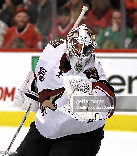 Mike Smith of the Arizona Coyotes knocks the puck away with his glove against the Chicago Blackhawks at the United Center on December 6, 2016 in...