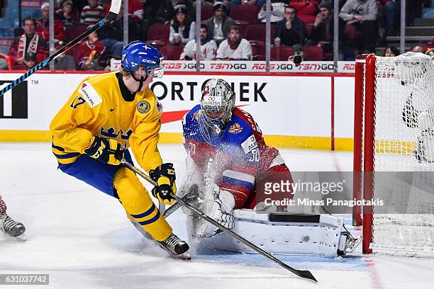 Fredrik Karlstrom of Team Sweden is stopped by goaltender Ilya Samsonov of Team Russia during the 2017 IIHF World Junior Championship bronze medal...