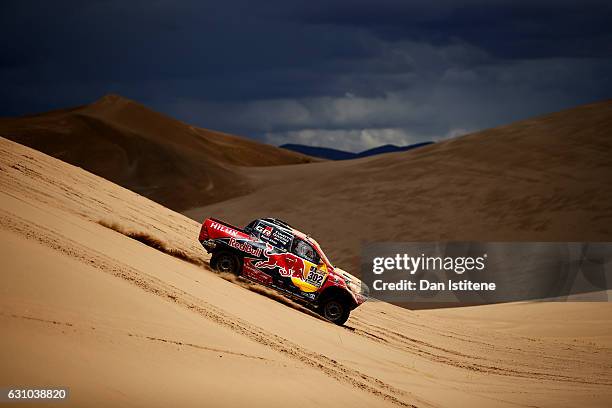 Giniel De Villiers of South Africa and Toyota Gazoo Racing drives with co-driver Dirk Von Zitzewitz of Germany in the Hilux Toyota car in the Classe...