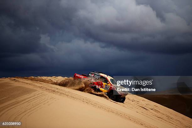 Giniel De Villiers of South Africa and Toyota Gazoo Racing drives with co-driver Dirk Von Zitzewitz of Germany in the Hilux Toyota car in the Classe...