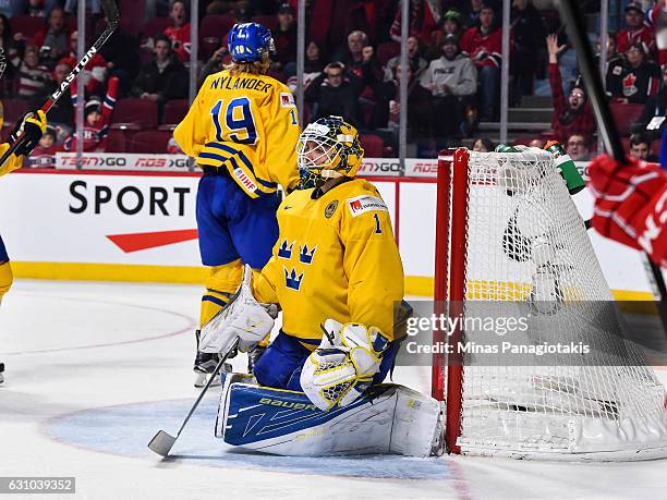 Felix Sandstrom of Team Sweden reacts after allowing a goal in overtime during the 2017 IIHF World Junior Championship bronze medal game against Team...