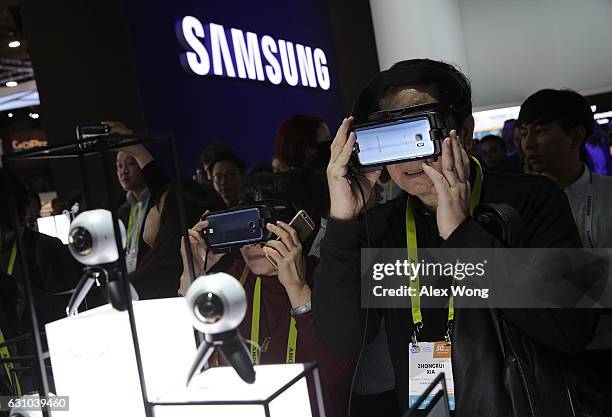 Attendees try out the Gear VR headset at the Samsung booth during CES 2017 at the Las Vegas Convention Center on January 5, 2017 in Las Vegas,...