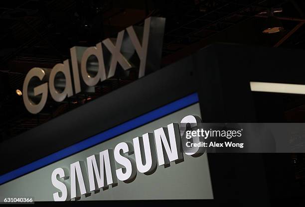 Samsung and a Galaxy signs are seen at the Samsung booth during CES 2017 at the Las Vegas Convention Center on January 5, 2017 in Las Vegas, Nevada....