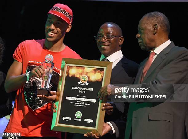 Former Africa's best player Gabonese Pierre-Emerick Aubameyang receives the second best player award from Nigeria's Sports Minister Solomon Dalung...