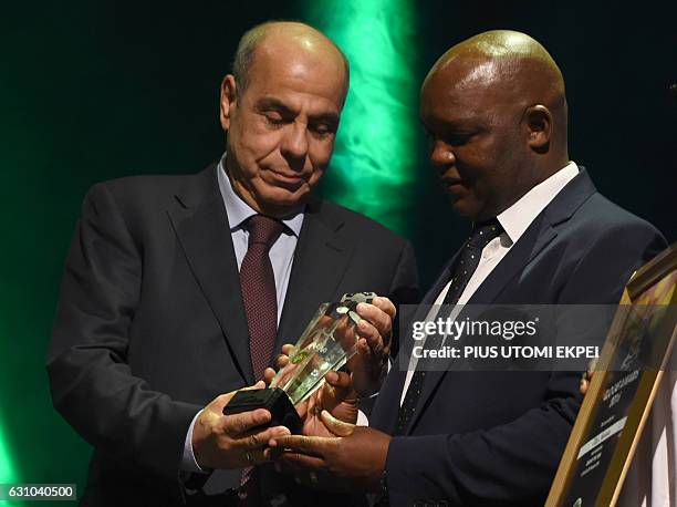 Coach of the Year Mamelodi Sundowns Pitso Mosimane receives his award during the African Footballer of the Year Awards in Abuja, on January 5, 2017....