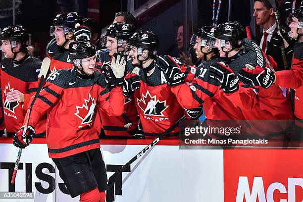 Jeremy Lauzon of Team Canada celebrates his first period goal with teammates on the bench during the 2017 IIHF World Junior Championship gold medal...