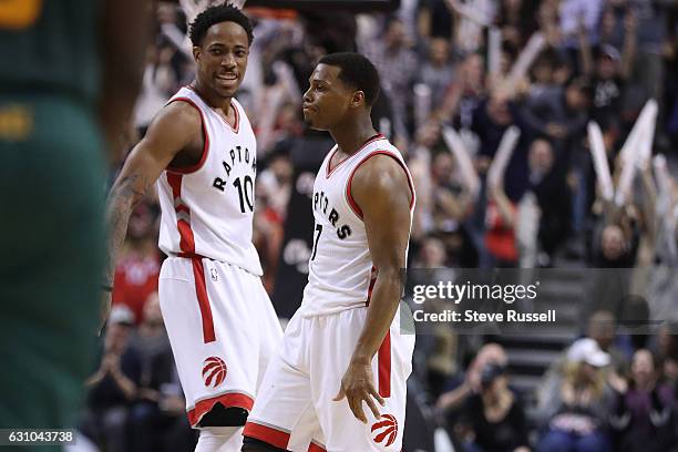 Toronto Raptors guard DeMar DeRozan and Kyle Lowry celebrate a clutch basket as the Toronto Raptors beat the Utah Jazz 101-93 at Air Canada Centre in...